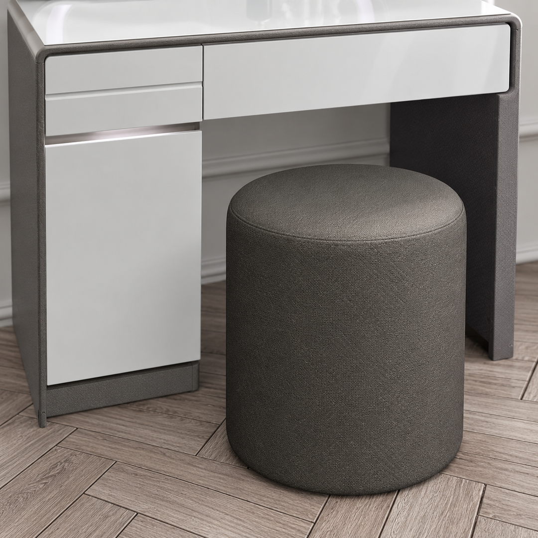 Included dark grey round upholstered stool
