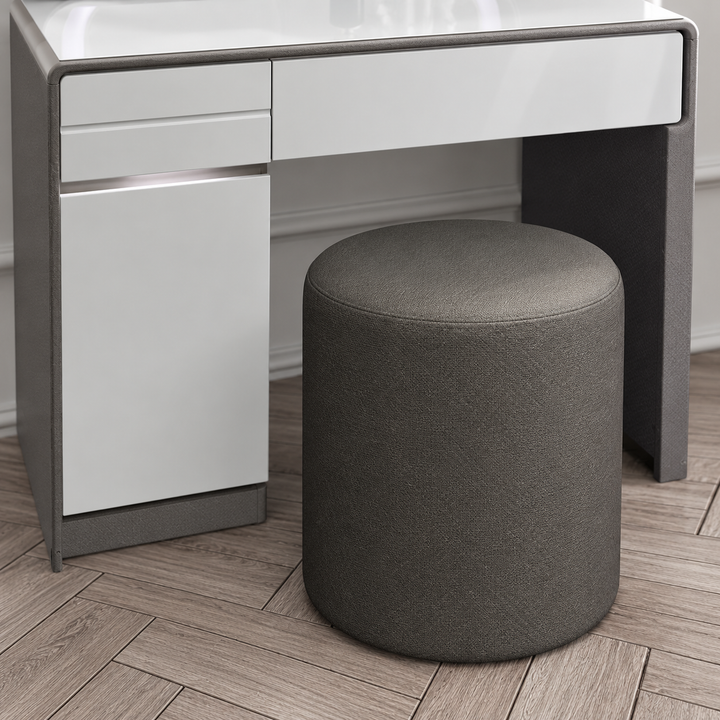Included dark grey round upholstered stool