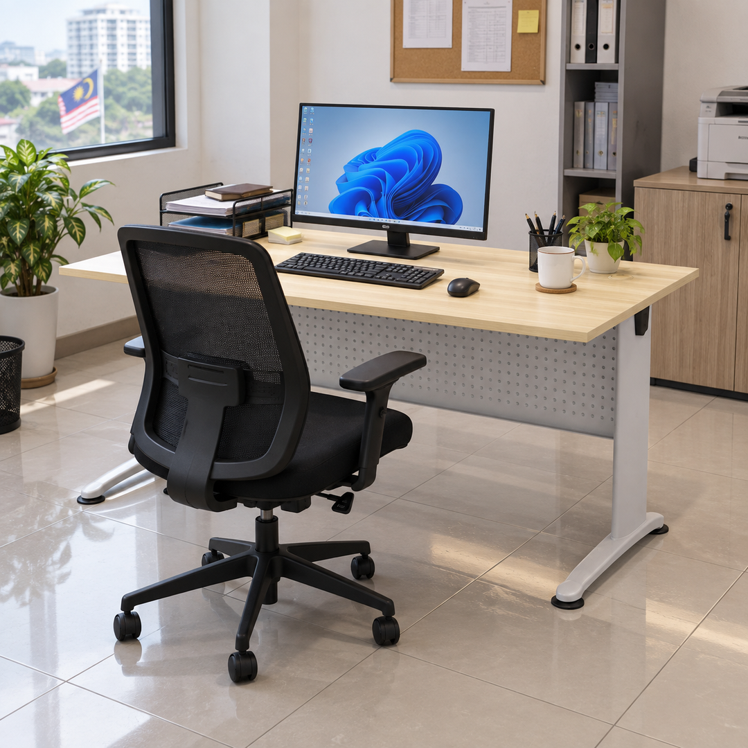 B-Series standard office table in a practical Malaysian office, operator on the longer-foot seating side