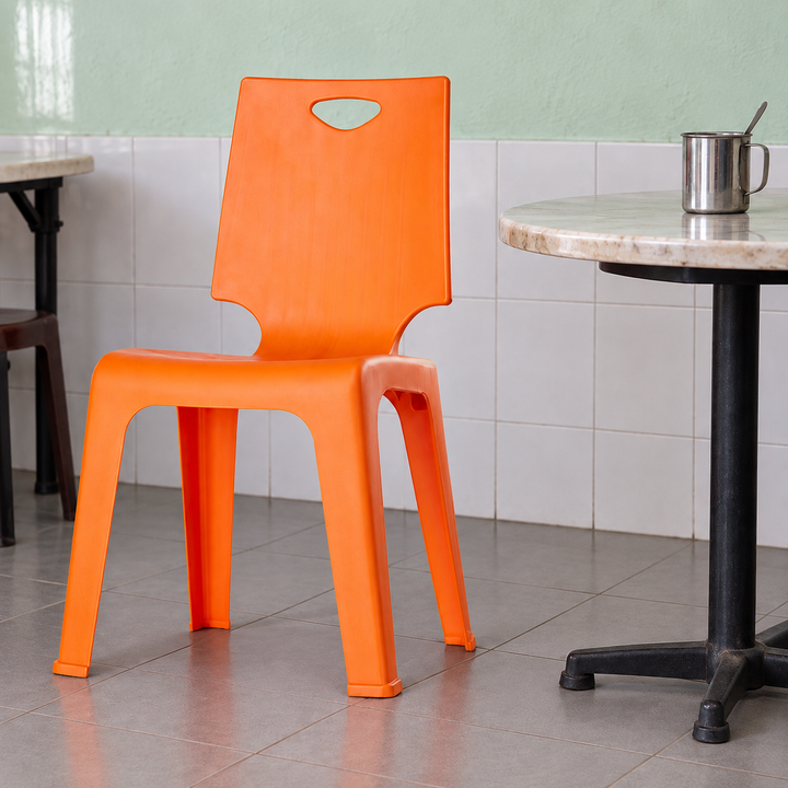 Orange MS999 Magnum V-Chair beside a table in a tidy Malaysian kopitiam