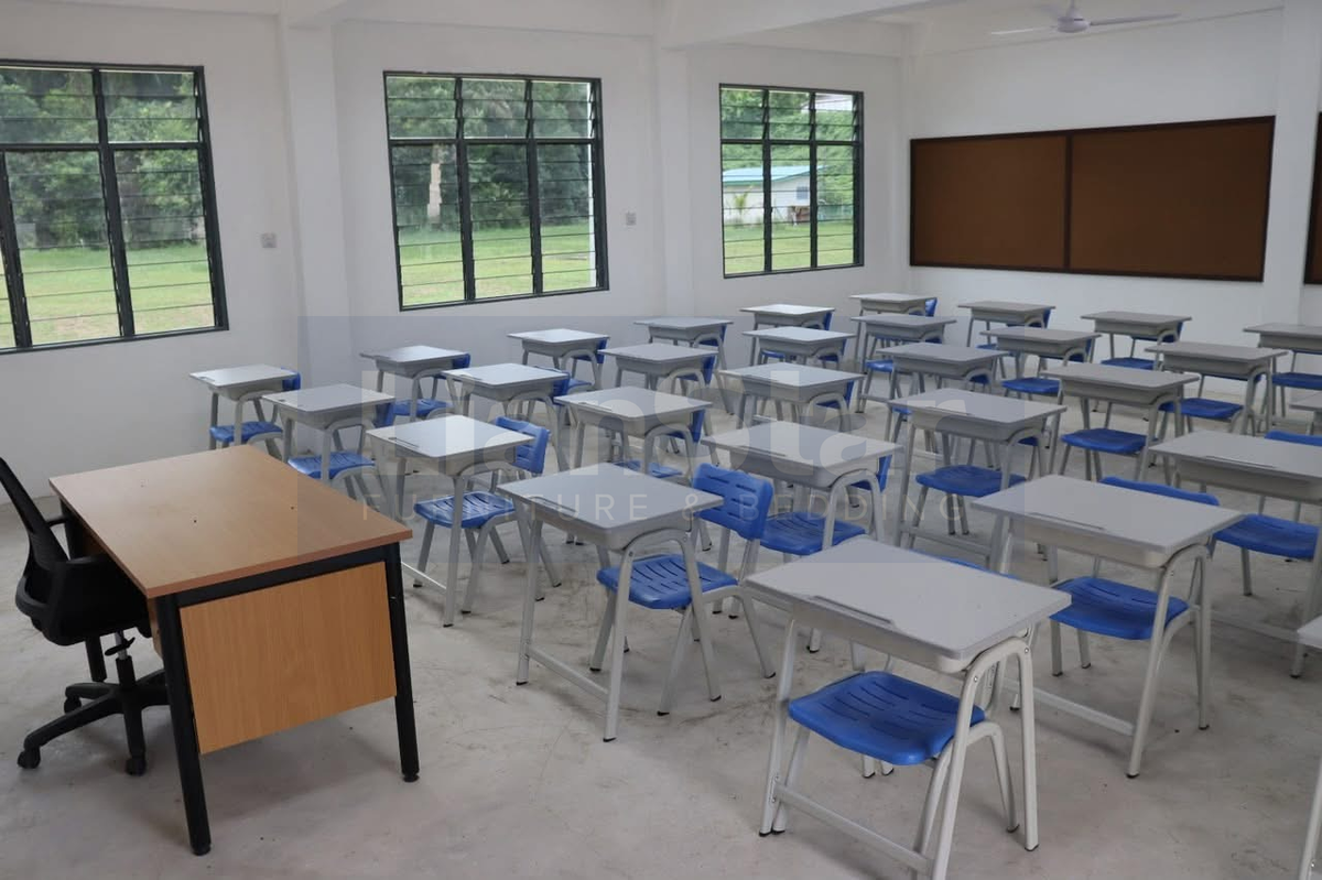Student desks and chairs viewed from the front of the classroom.