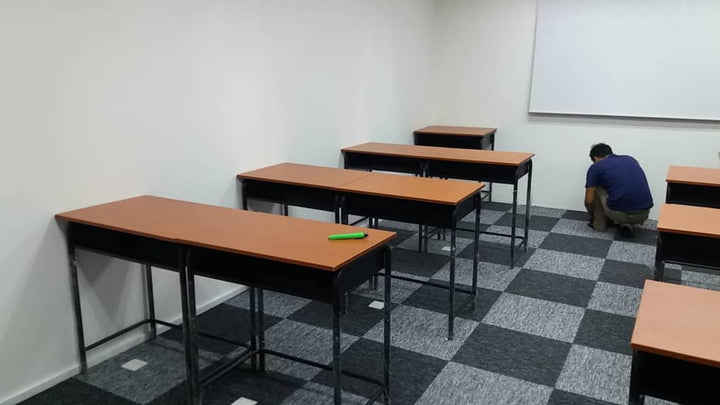 Classroom arrangement of individual STD-002 school tables with brown tops and black iron frames